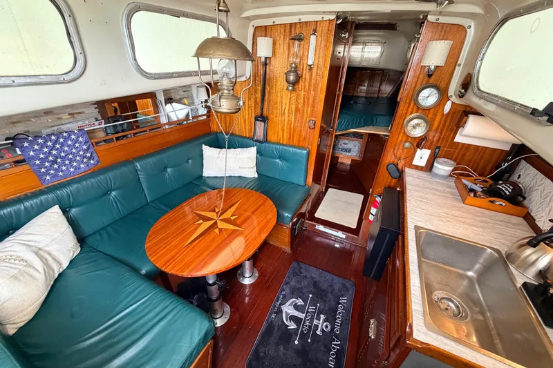 Slide: The Image of Interior of a 1964 Columbia 33 sailboat with cozy seating and nautical decor. - 27
