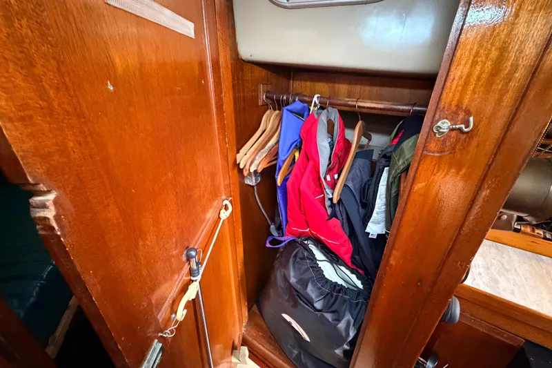 Slide: The Image of Wooden closet with clothing in a 1964 Columbia 33 yacht. - 30