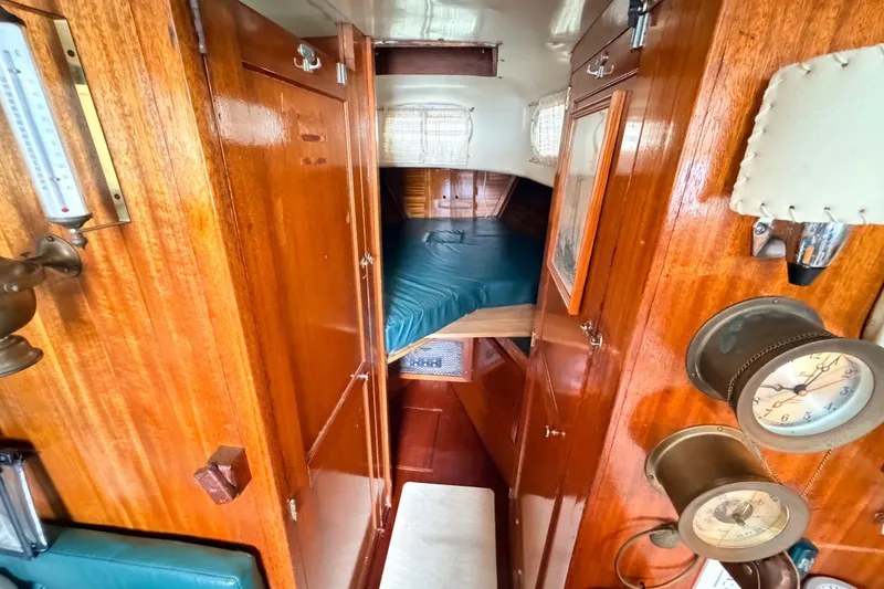 Slide: The Image of Interior of a 1964 Columbia 33 sailboat with wooden paneling and nautical instruments. - 31