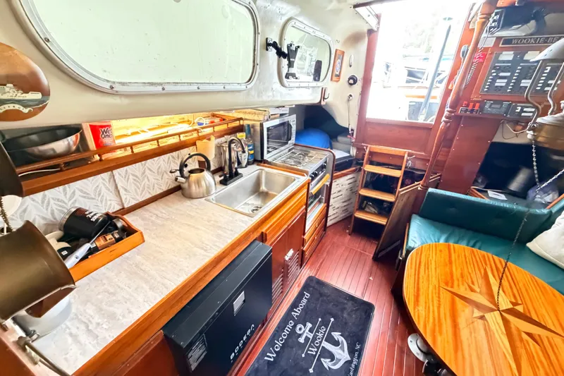 Slide: The Image of Interior of a 1964 Columbia 33 sailboat with kitchen and seating area. - 35