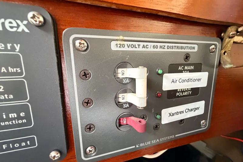 Slide: The Image of Electrical panel on a 1964 Columbia 33 boat with labeled switches and indicators. - 46