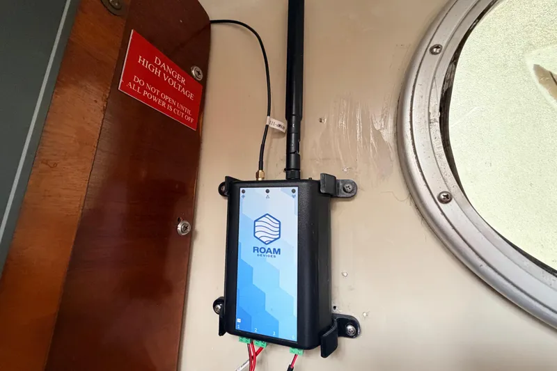 Slide: The Image of Device installed on a 1964 Columbia 33 sailboat, near a high voltage warning sign. - 49