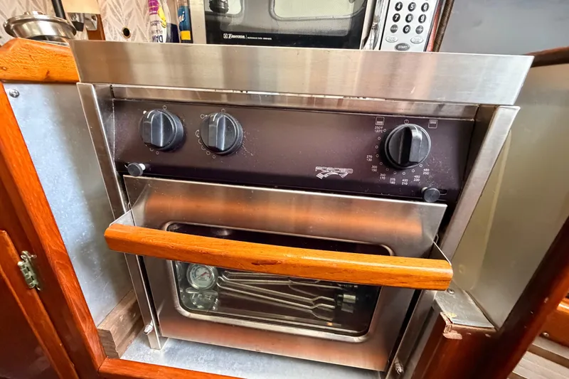 Slide: The Image of Stainless steel oven with wooden handle in a 1964 Columbia 33 boat kitchen. - 54