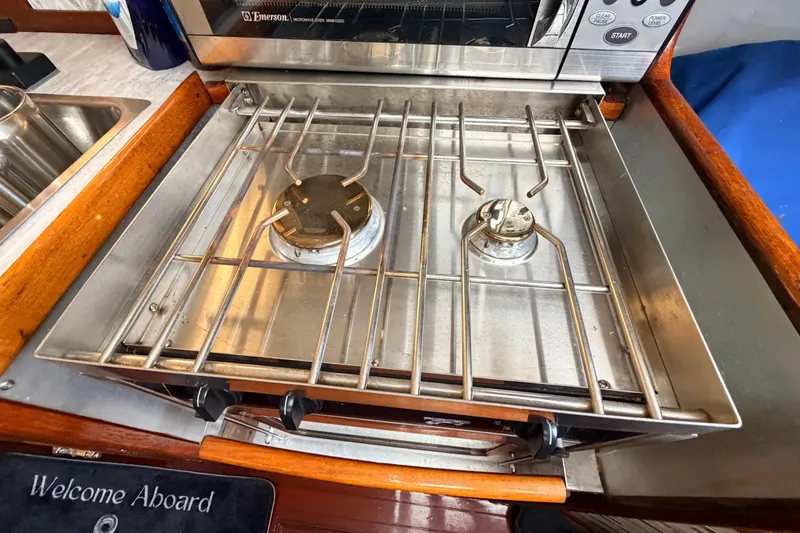 Slide: The Image of Stainless steel stove on a 1964 Columbia 33 sailboat, featuring two burners. - 56