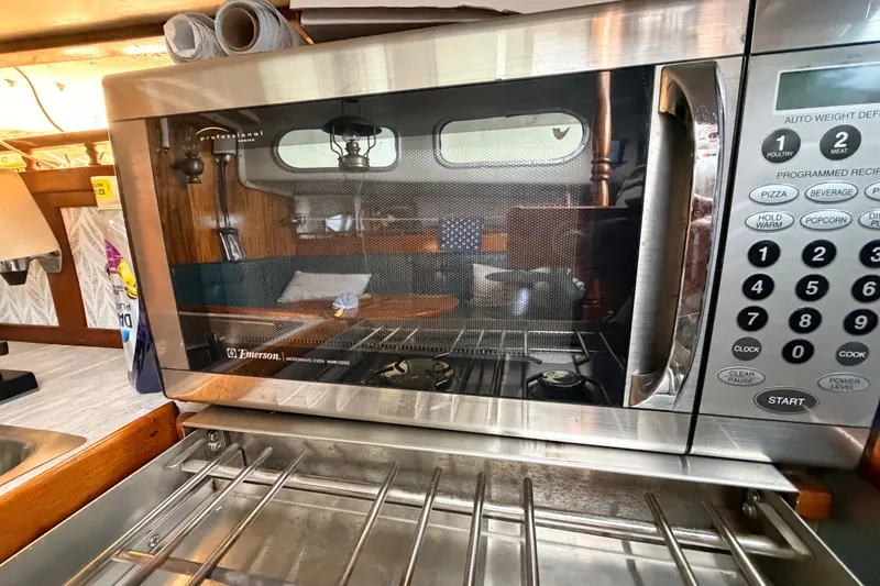 Slide: The Image of Microwave oven inside a 1964 Columbia 33 sailboat kitchen area. - 57