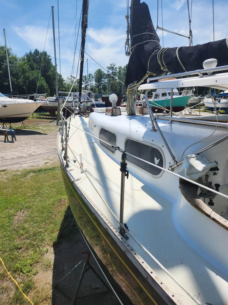 Slide: The Image of 1964 Columbia 33 sailboat docked in a marina on a sunny day. - 6