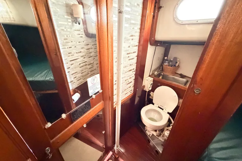 Slide: The Image of 1964 Columbia 33 yacht bathroom with wooden interior and compact amenities. - 64