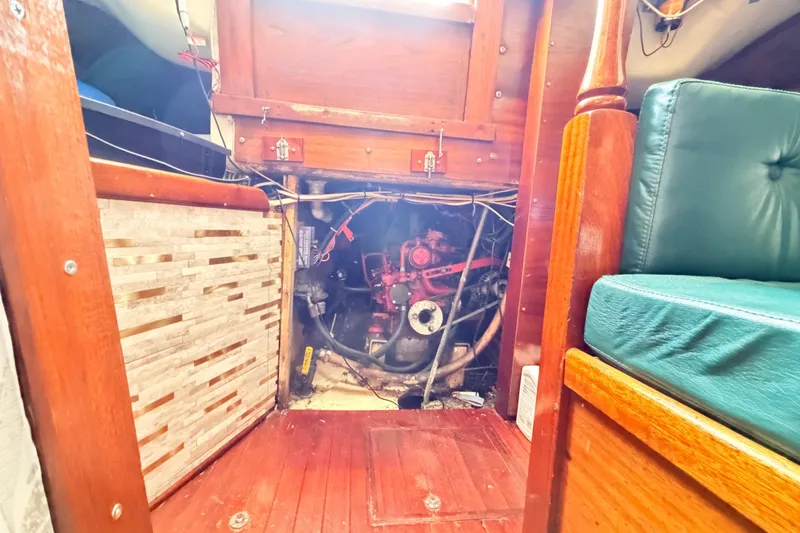 Slide: The Image of Engine compartment of a 1964 Columbia 33 sailboat, featuring wooden interior and visible engine components. - 66