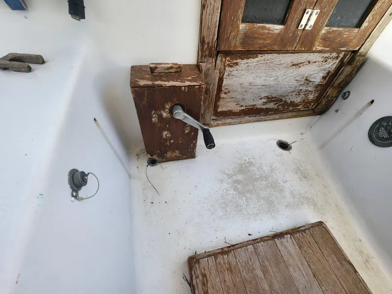 Slide: The Image of 1964 Columbia 33 boat interior with weathered wood and steering mechanism. - 8