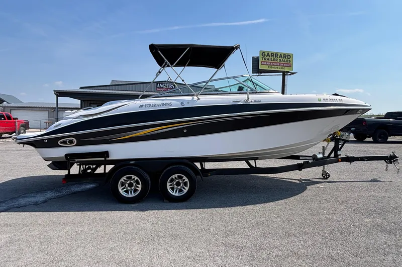 The Image of 2008 Four Winns H260 RS boat on trailer at dealership lot. - 1