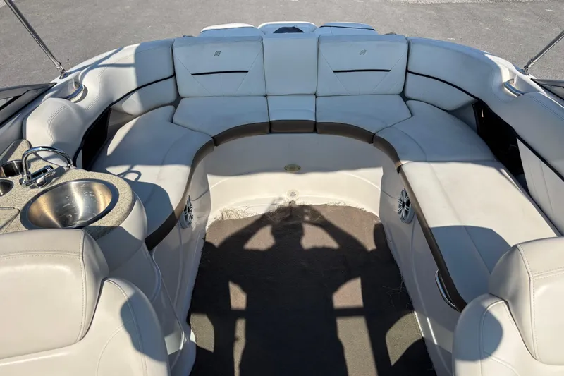 Slide: The Image of Interior of 2008 Four Winns H260 RS boat with white seating and built-in sink. - 12