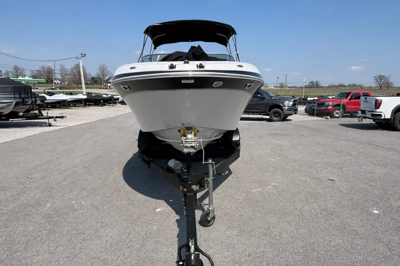 Slide: The Image of 2008 Four Winns H260 RS boat on trailer in parking lot. - 4