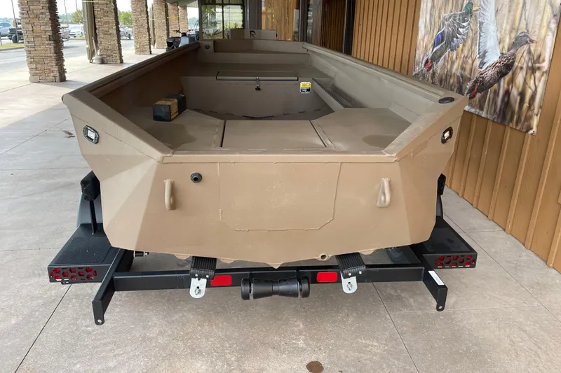 Slide: The Image of 2026 Reaper 653 Timber Reaper boat on trailer, parked outdoors. - 2