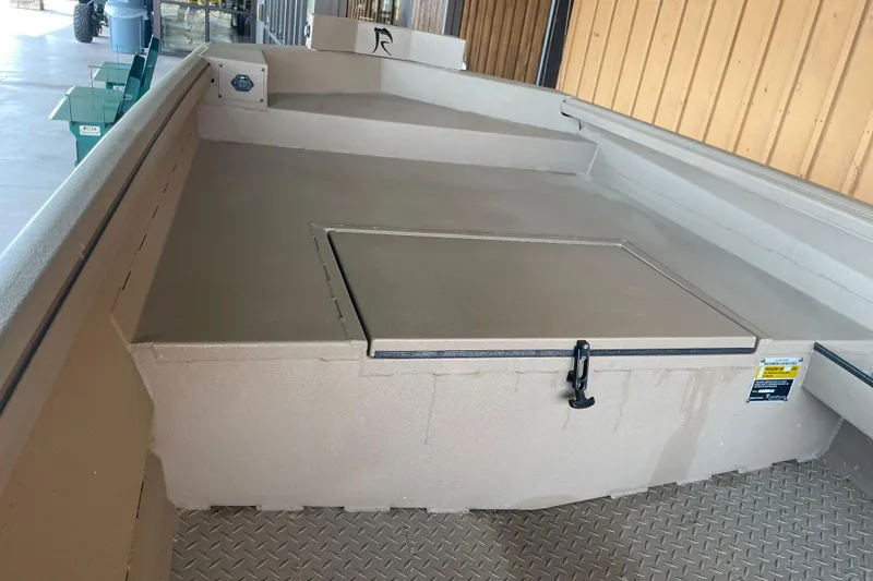 Slide: The Image of 2026 Reaper 653 Timber Reaper boat interior with storage compartment and diamond plate flooring. - 9