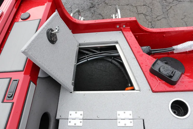 Slide: The Image of Open storage compartment on 2026 Smoker Craft Ultima 182 boat, showing interior wiring and components. - 12