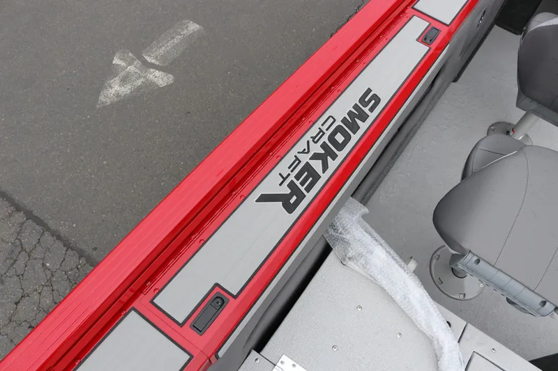 Slide: The Image of 2026 Smoker Craft Ultima 182 boat interior with red trim and gray seating. - 15