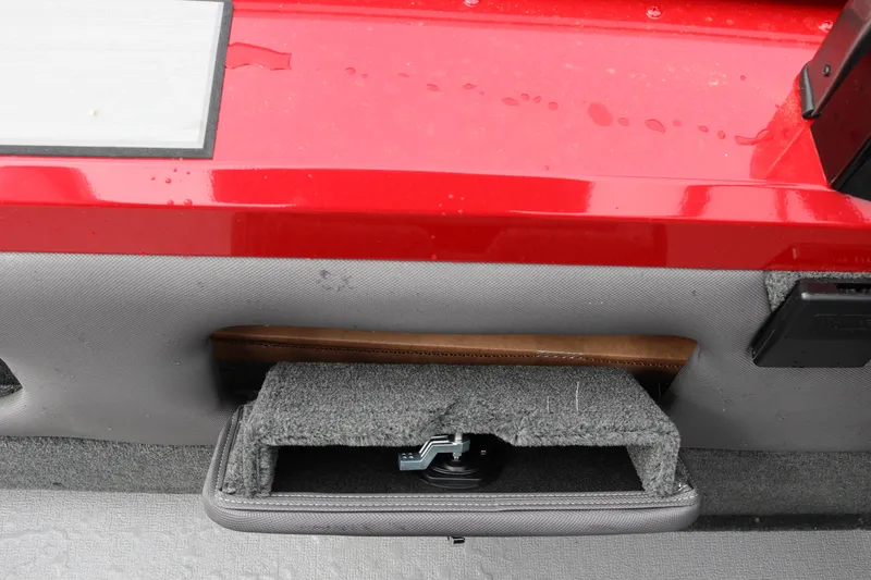 Slide: The Image of 2026 Smoker Craft Ultima 182 boat interior storage compartment with red and gray design. - 22