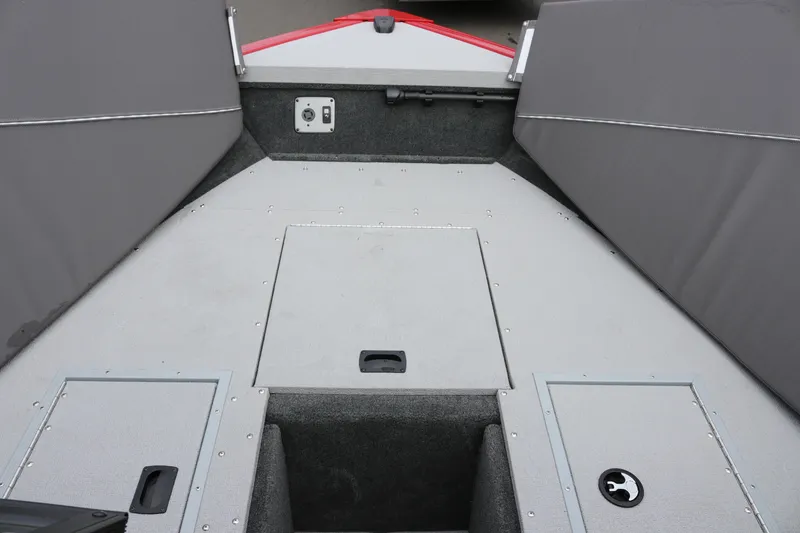 Slide: The Image of 2026 Smoker Craft Ultima 182 boat interior with storage compartments and gray upholstery. - 26