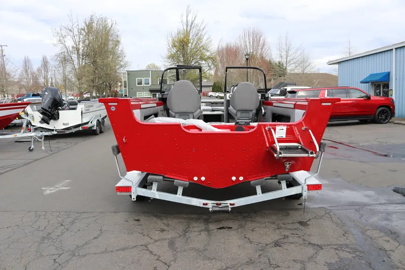 Slide: The Image of 2026 Smoker Craft Ultima 182 boat, red exterior, parked on a trailer in a lot. - 4