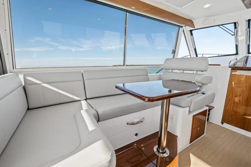 Slide: The Image of Luxurious interior of 2026 MJM 47 R yacht with sleek seating and wooden table. - 13