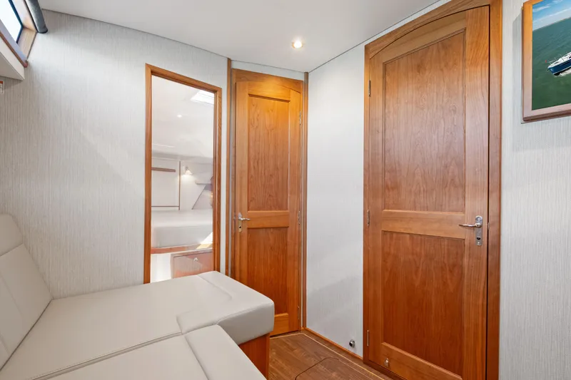 Slide: The Image of Interior of 2026 MJM 47 R yacht with wooden doors and modern seating. - 28