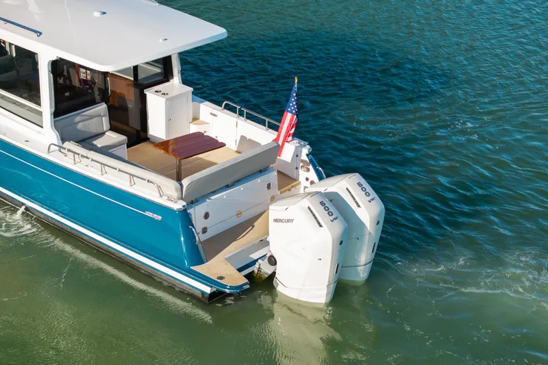 Slide: The Image of 2026 MJM 47 R yacht with dual Mercury engines on blue water. - 41