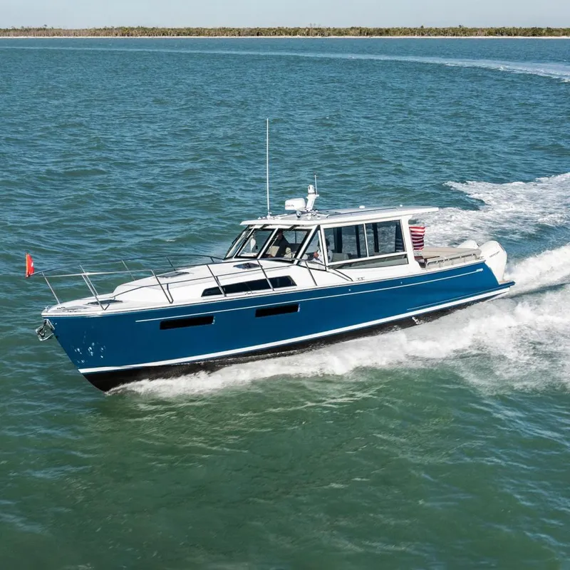 The Image of MJM 47R 2026 yacht cruising on open water, blue hull. - 0