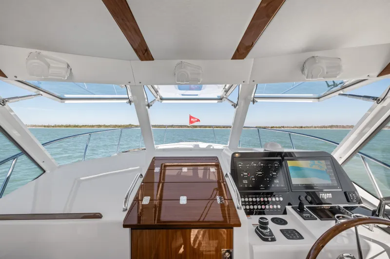 Slide: The Image of Interior view of 2026 MJM 47 R yacht cockpit with navigation controls and panoramic windows. - 5