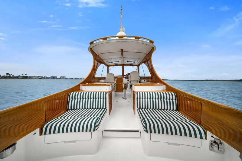 Slide: The Image of 2013 Hinckley Picnic Boat 37 MKIII with striped seating on calm water. - 12