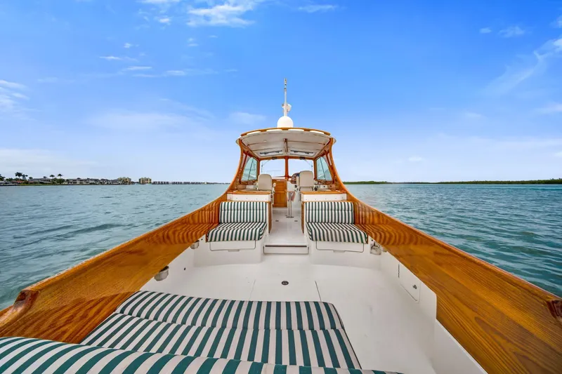 Slide: The Image of 2013 Hinckley Picnic Boat 37 MKIII cruising on serene waters under a clear blue sky. - 13