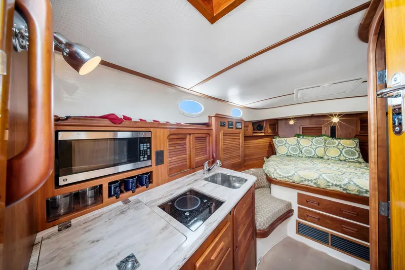 Slide: The Image of Luxurious interior of 2013 Hinckley Picnic Boat 37 MKIII with kitchenette and cozy sleeping area. - 16