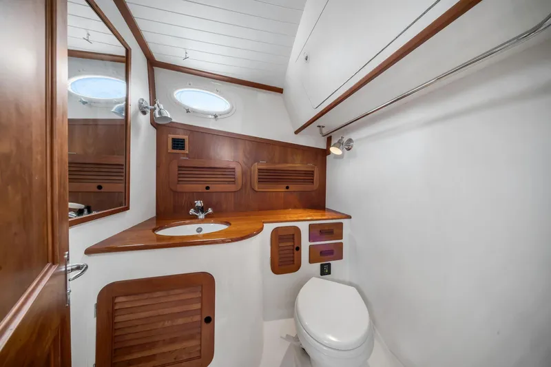 Slide: The Image of Elegant bathroom interior of 2013 Hinckley Picnic Boat 37 MKIII with wooden accents and modern fixtures. - 17