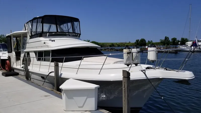Slide: The Image of 1998 Carver 445 Aft Cabin Motor Yacht docked at marina. - 1