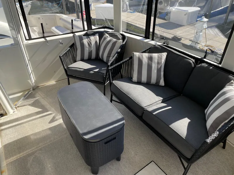 Slide: The Image of 1998 Carver 445 Aft Cabin Motor Yacht interior with stylish seating and striped cushions. - 21