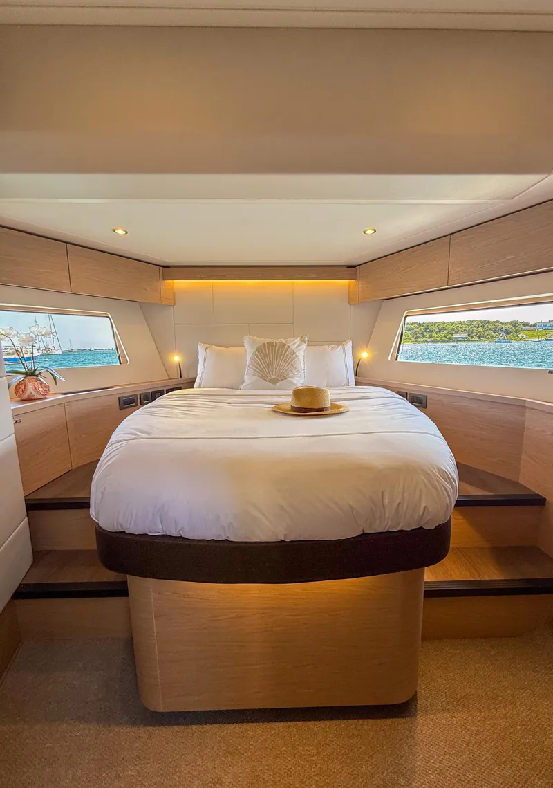 Slide: The Image of Luxurious bedroom in 2026 Beneteau Swift Trawler 54 with scenic ocean views. - 12