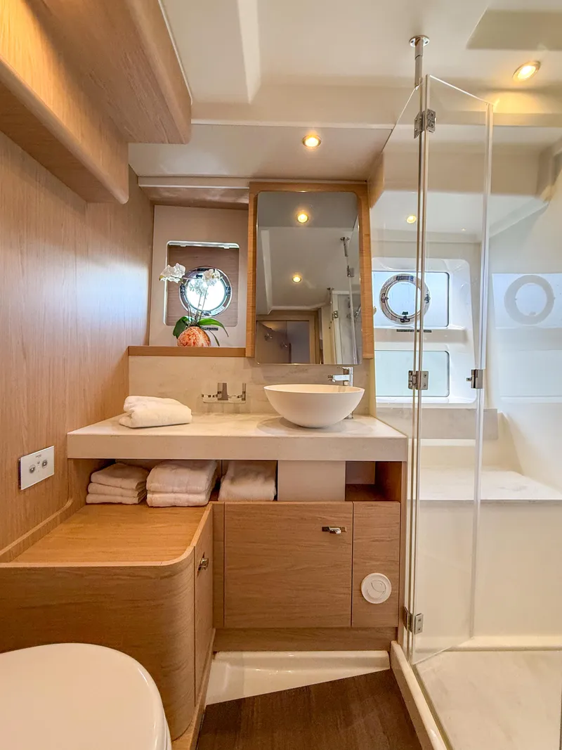 Slide: The Image of Luxurious bathroom in 2026 Beneteau Swift Trawler 54, featuring modern fixtures and elegant wood finishes. - 14