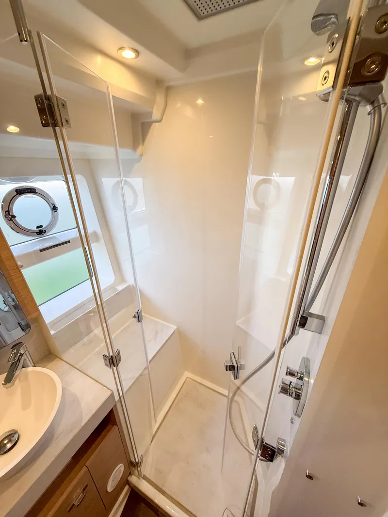 Slide: The Image of Bathroom interior of 2026 Beneteau Swift Trawler 54, featuring modern shower and sink. - 15