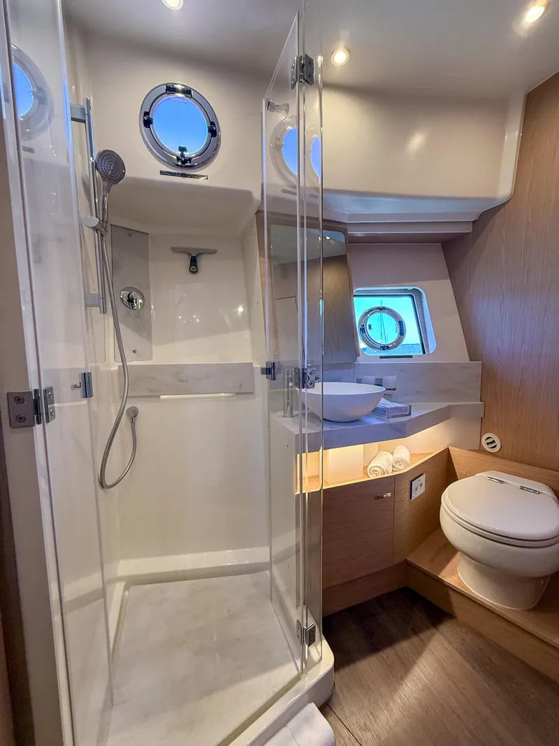 Slide: The Image of Luxurious bathroom in 2026 Beneteau Swift Trawler 54, featuring shower, sink, and toilet. - 18