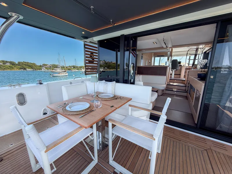 Slide: The Image of Luxurious 2026 Beneteau Swift Trawler 54 yacht with elegant outdoor dining area. - 22