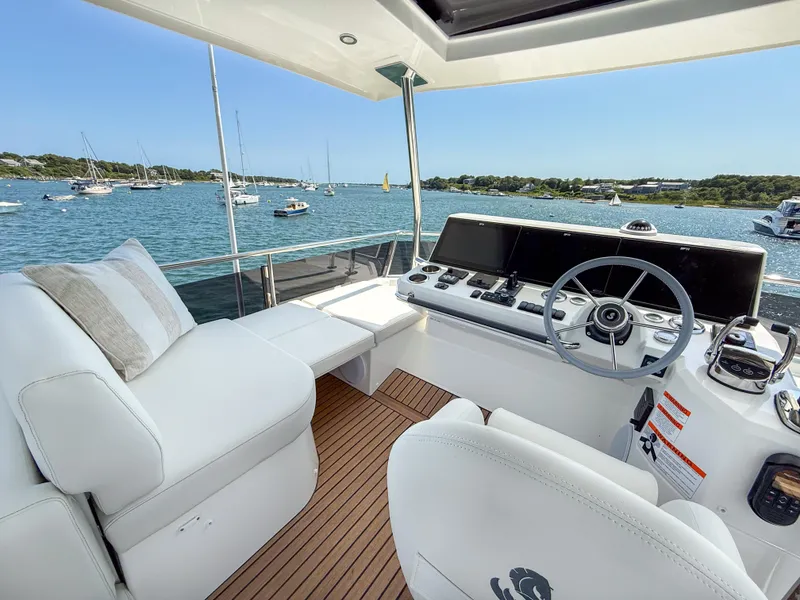 Slide: The Image of 2026 Beneteau Swift Trawler 54 helm with luxurious seating and scenic ocean view. - 23