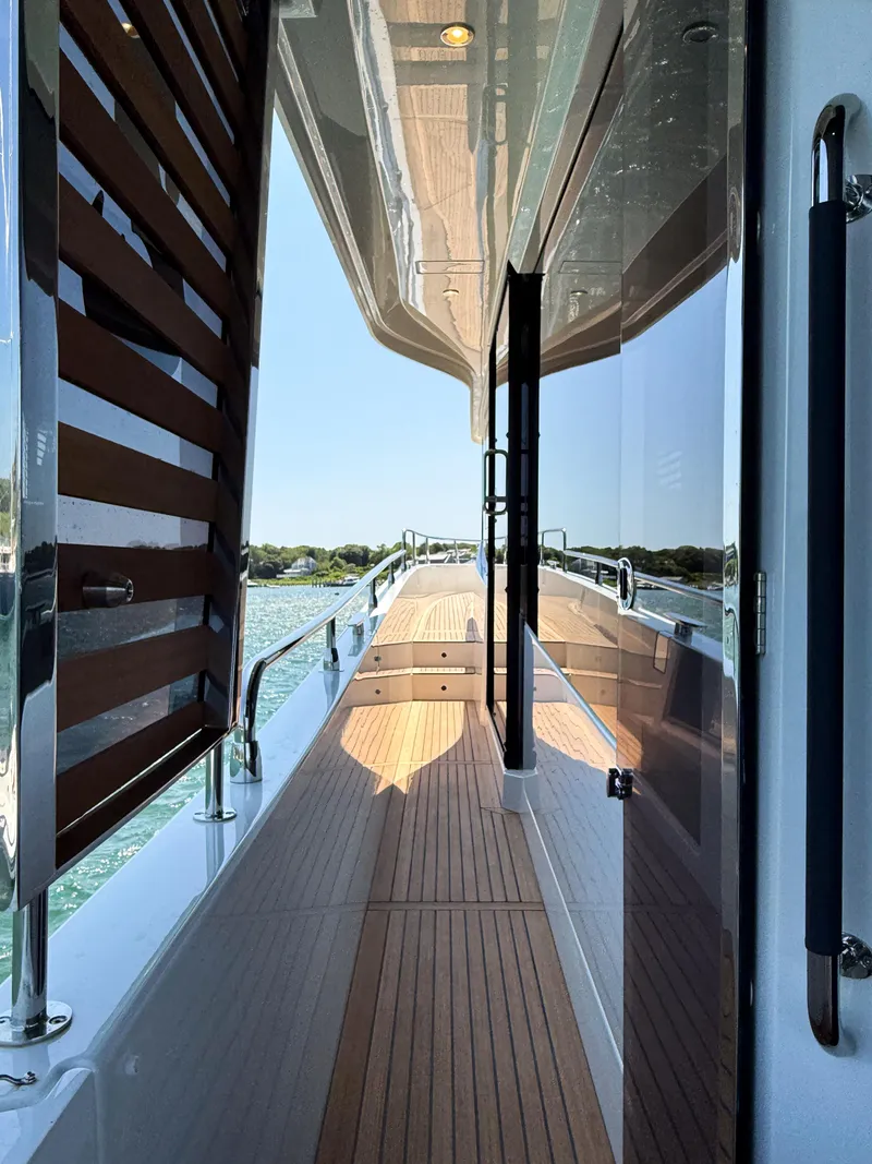 Slide: The Image of 2026 Beneteau Swift Trawler 54 deck view with sleek design and wooden flooring. - 30