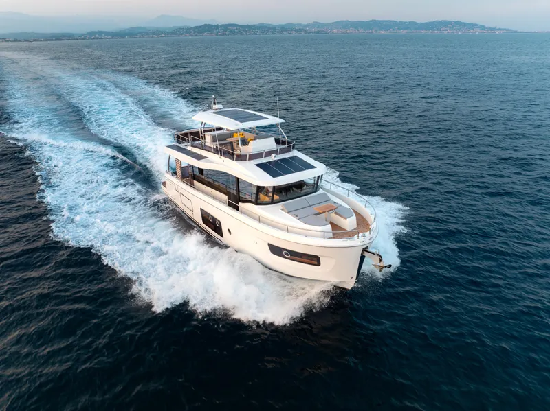Slide: The Image of 2026 Beneteau Swift Trawler 54 cruising on open sea, showcasing sleek design and performance. - 34
