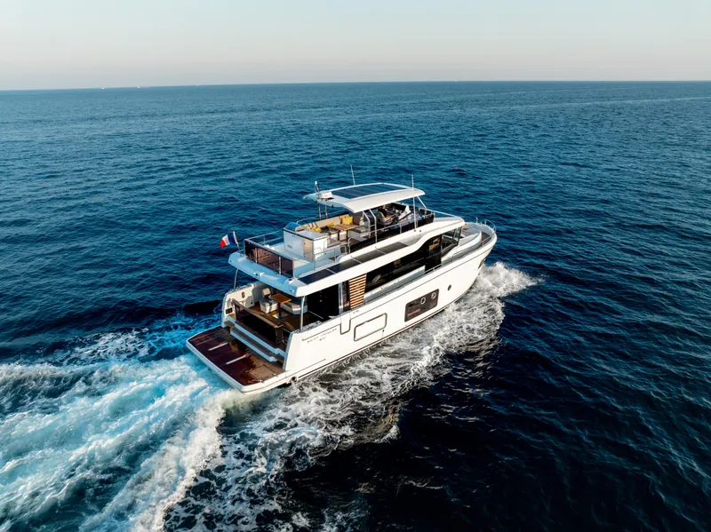 Slide: The Image of 2026 Beneteau Swift Trawler 54 cruising on open sea, showcasing luxury and performance. - 35