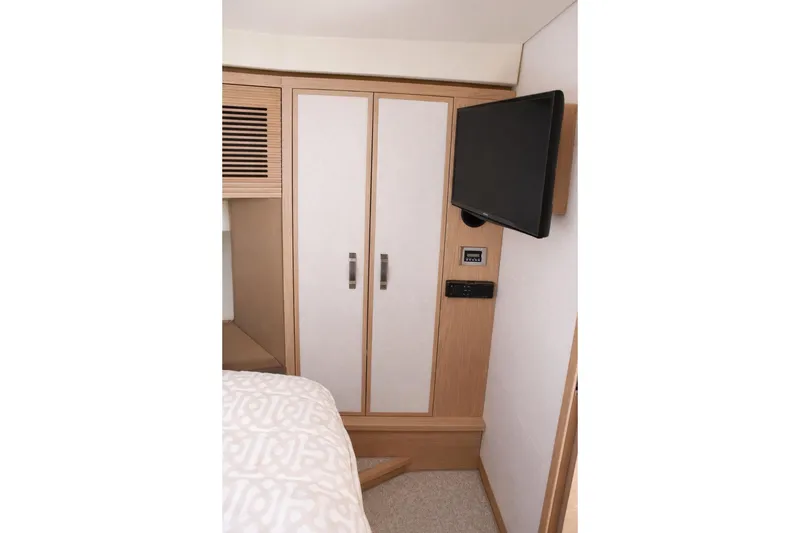 Slide: The Image of Interior of 2016 Beneteau Monte Carlo 5 yacht with TV and wardrobe. - 26