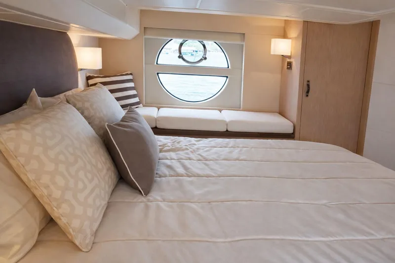 Slide: The Image of Luxurious bedroom interior of 2016 Beneteau Monte Carlo 5 yacht with elegant bedding and porthole view. - 34