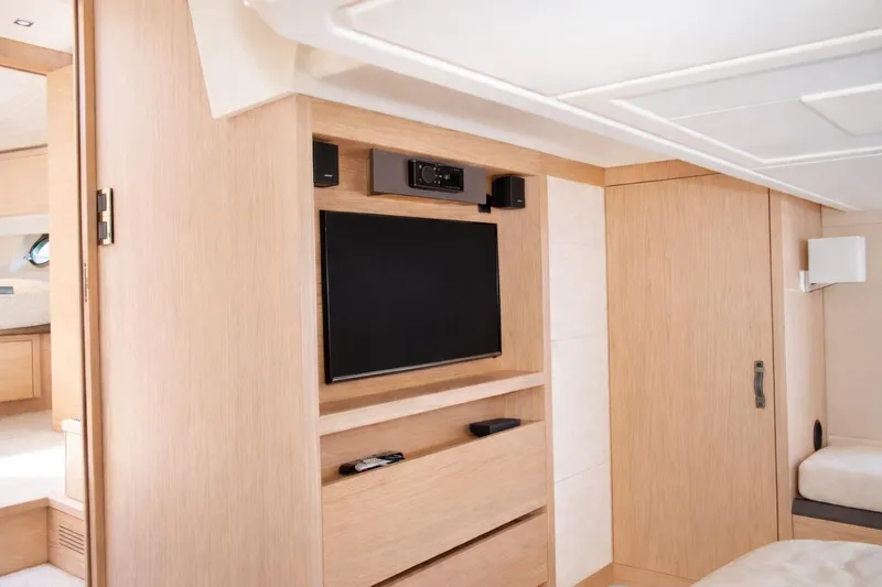 Slide: The Image of Interior of 2016 Beneteau Monte Carlo 5 yacht with modern entertainment system and light wood finish. - 37