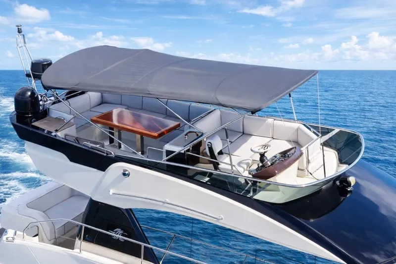 Slide: The Image of 2016 Beneteau Monte Carlo 5 yacht with spacious flybridge and ocean backdrop. - 46