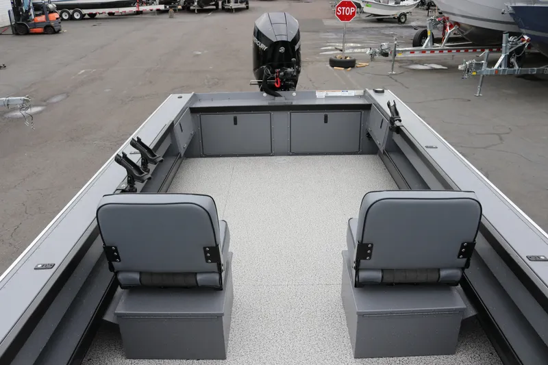 Slide: The Image of 2026 Alumaweld Super Vee Pro 23 boat interior with seating and motor. - 16