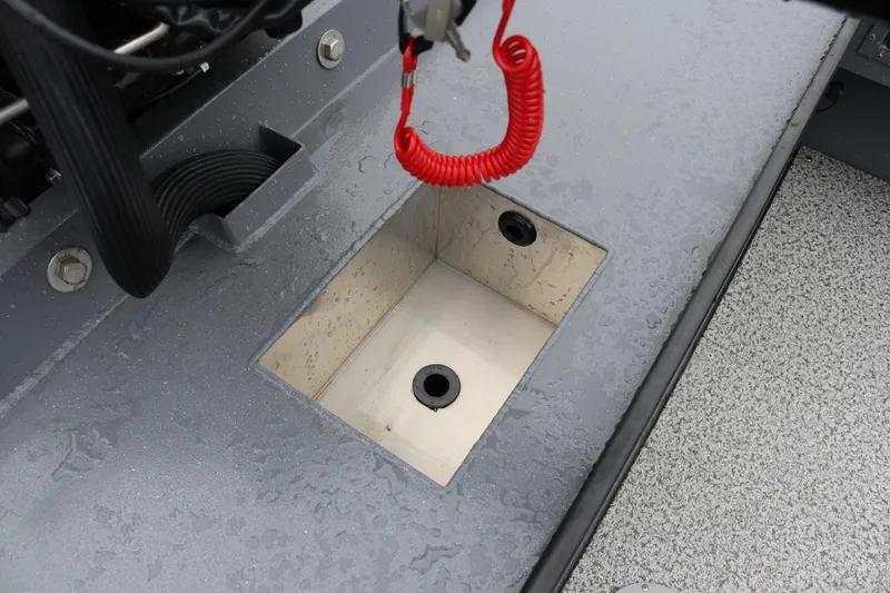 Slide: The Image of Alumaweld Super Vee Pro 23 boat detail, featuring a compartment with red safety cord. - 21