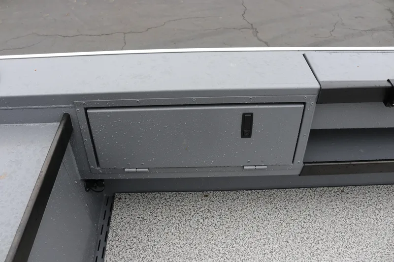 Slide: The Image of 2026 Alumaweld Super Vee Pro 23 boat interior storage compartment, gray finish. - 22